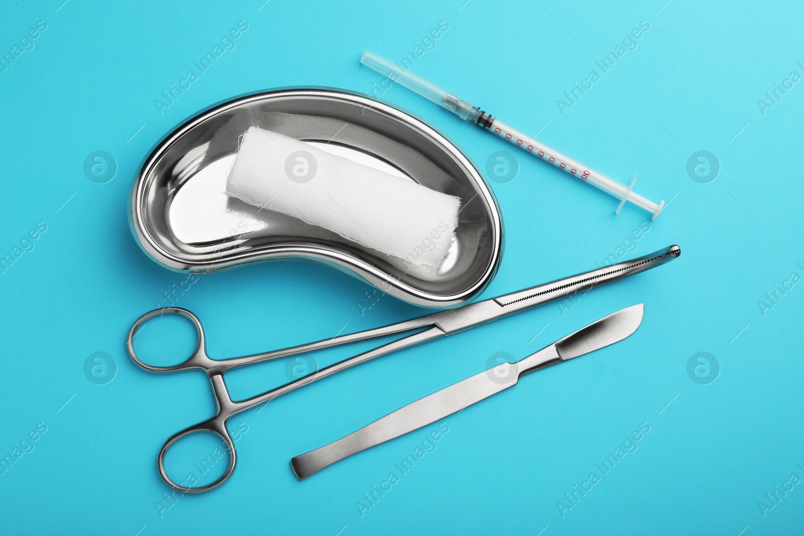 Photo of Different surgical tools on light blue background, flat lay