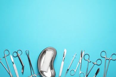 Photo of Different surgical tools on light blue background, flat lay. Space for text