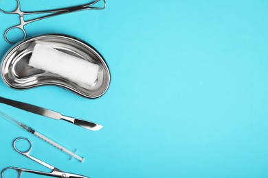 Photo of Different surgical tools on light blue background, flat lay. Space for text