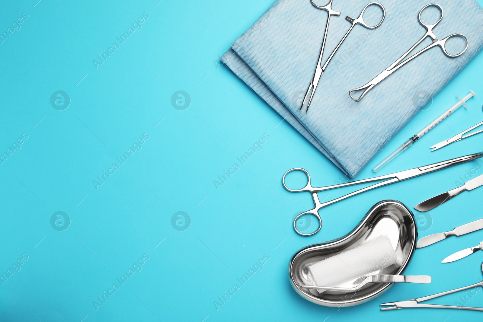 Photo of Different surgical tools on light blue background, flat lay. Space for text