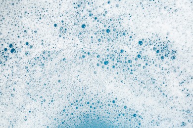 Photo of Detergent foam with bubbles as background, top view