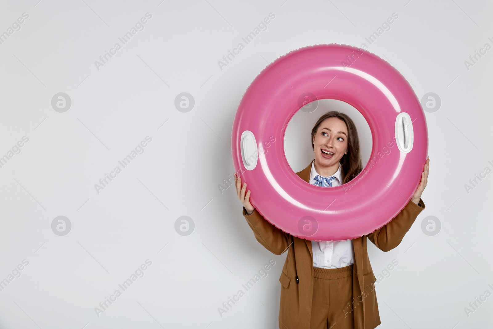 Photo of Businesswoman with inflatable ring on white background, space for text