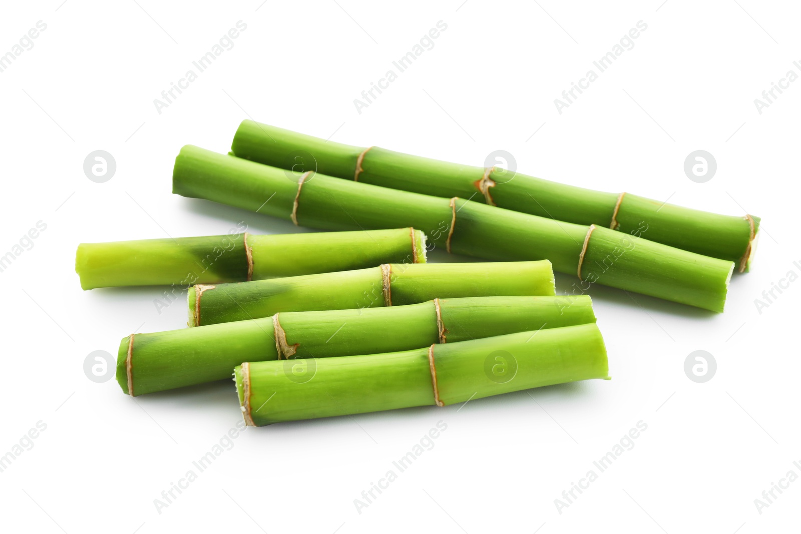 Photo of Cut green bamboo stems isolated on white