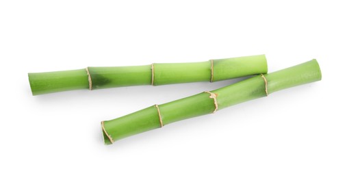 Photo of Cut green bamboo stems isolated on white, top view