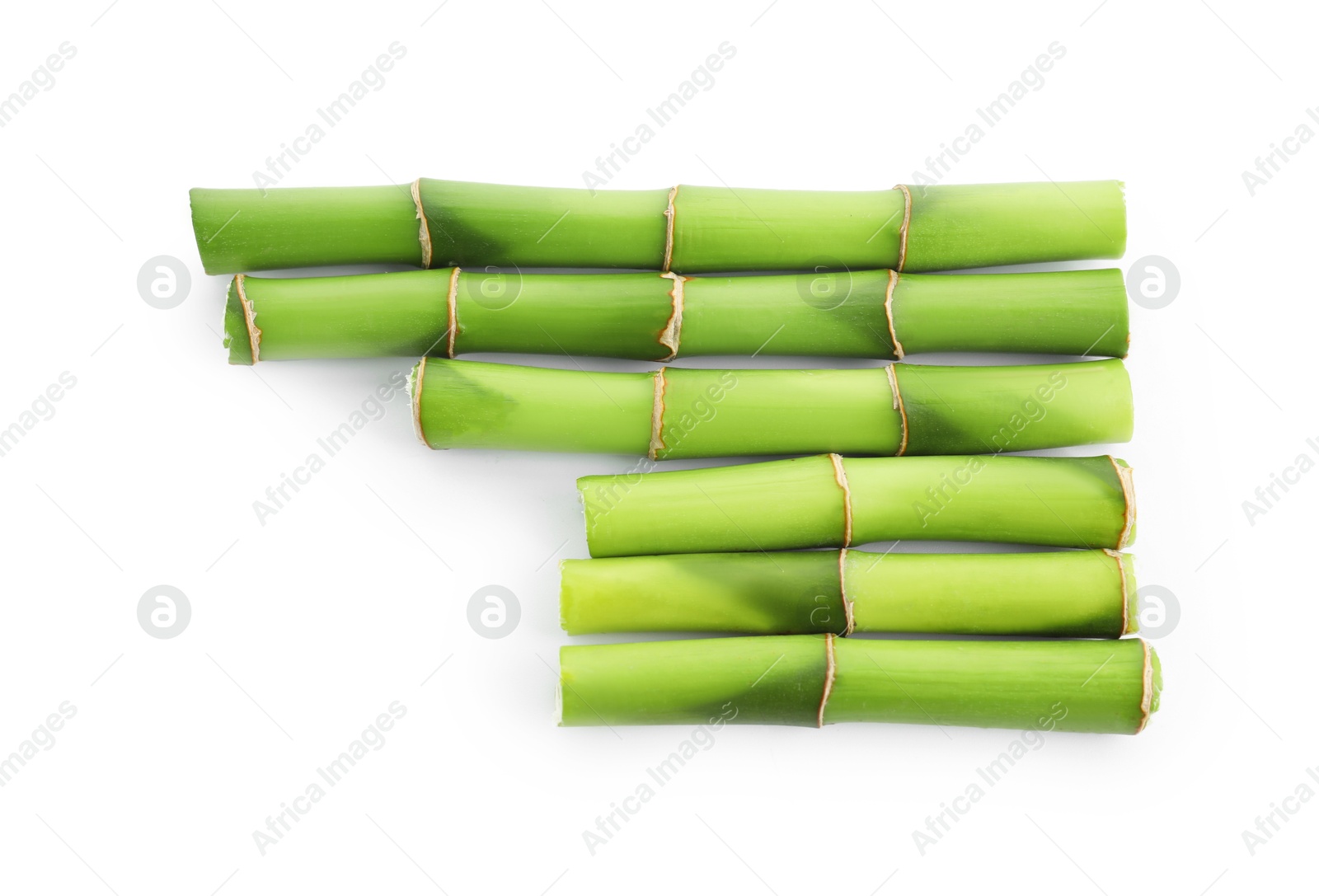 Photo of Cut green bamboo stems isolated on white, top view