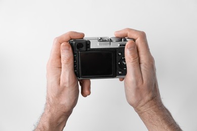 Photo of Photographer with vintage camera on white background, closeup