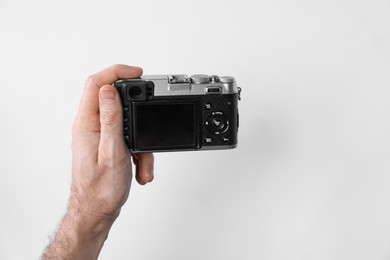 Photo of Photographer with vintage camera on white background, closeup. Space for text