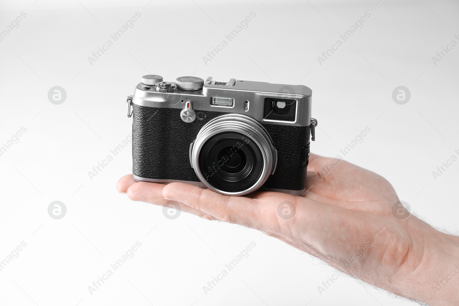 Photo of Photographer with vintage camera on white background, closeup