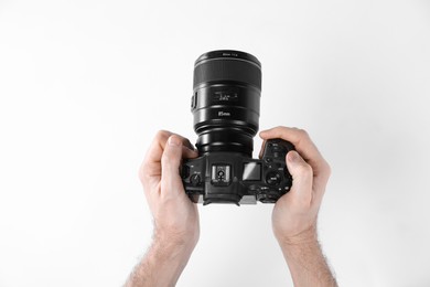 Photo of Photographer with professional camera on white background, closeup