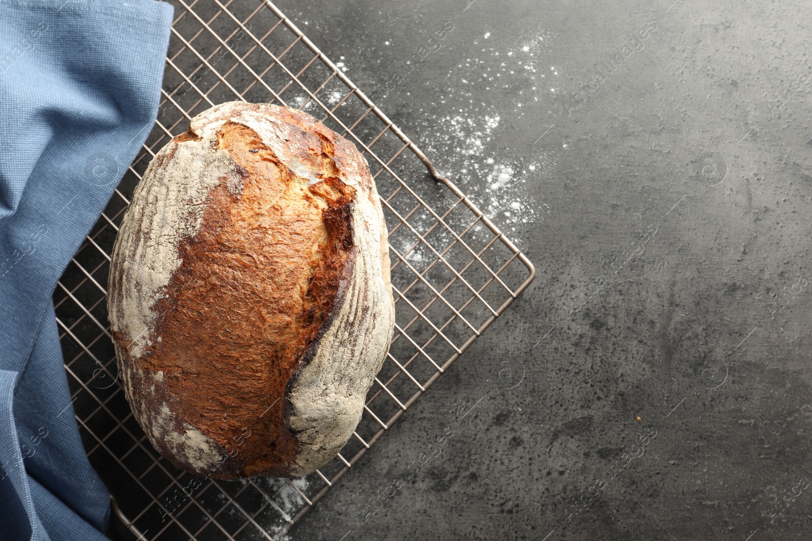 Photo of Freshly baked bread on grey table, top view. Space for text