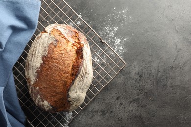 Photo of Freshly baked bread on grey table, top view. Space for text