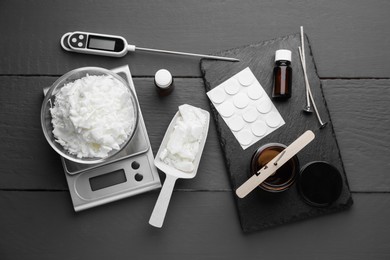 Photo of Soy wax, essential oils and different tools for making candles on grey wooden table, flat lay