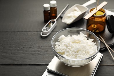 Photo of Soy wax, essential oils and different tools for making candles on grey wooden table, closeup. Space for text