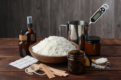 Photo of Soy wax and other supplies for making candles on wooden table