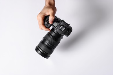 Photo of Photographer with professional camera on light background, above view