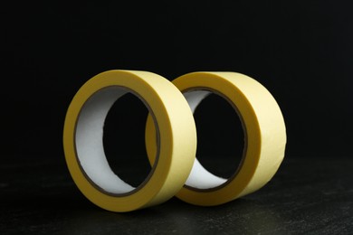 Rolls of masking tape on black table