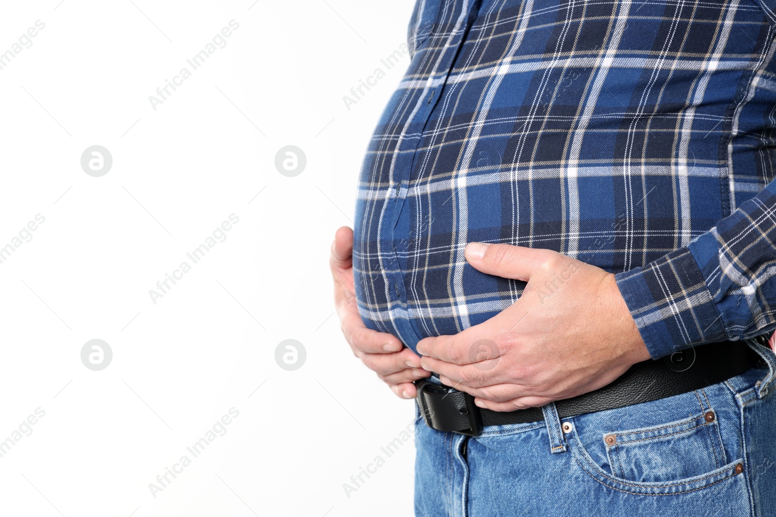 Photo of Overweight man in tight shirt on white background, closeup. Space for text