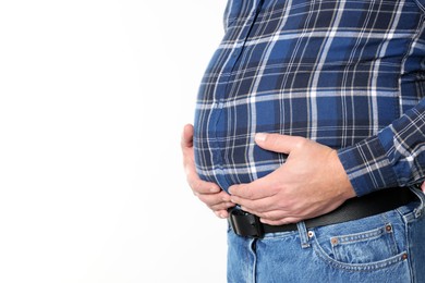 Photo of Overweight man in tight shirt on white background, closeup. Space for text