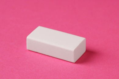 Photo of One eraser on pink background, closeup view