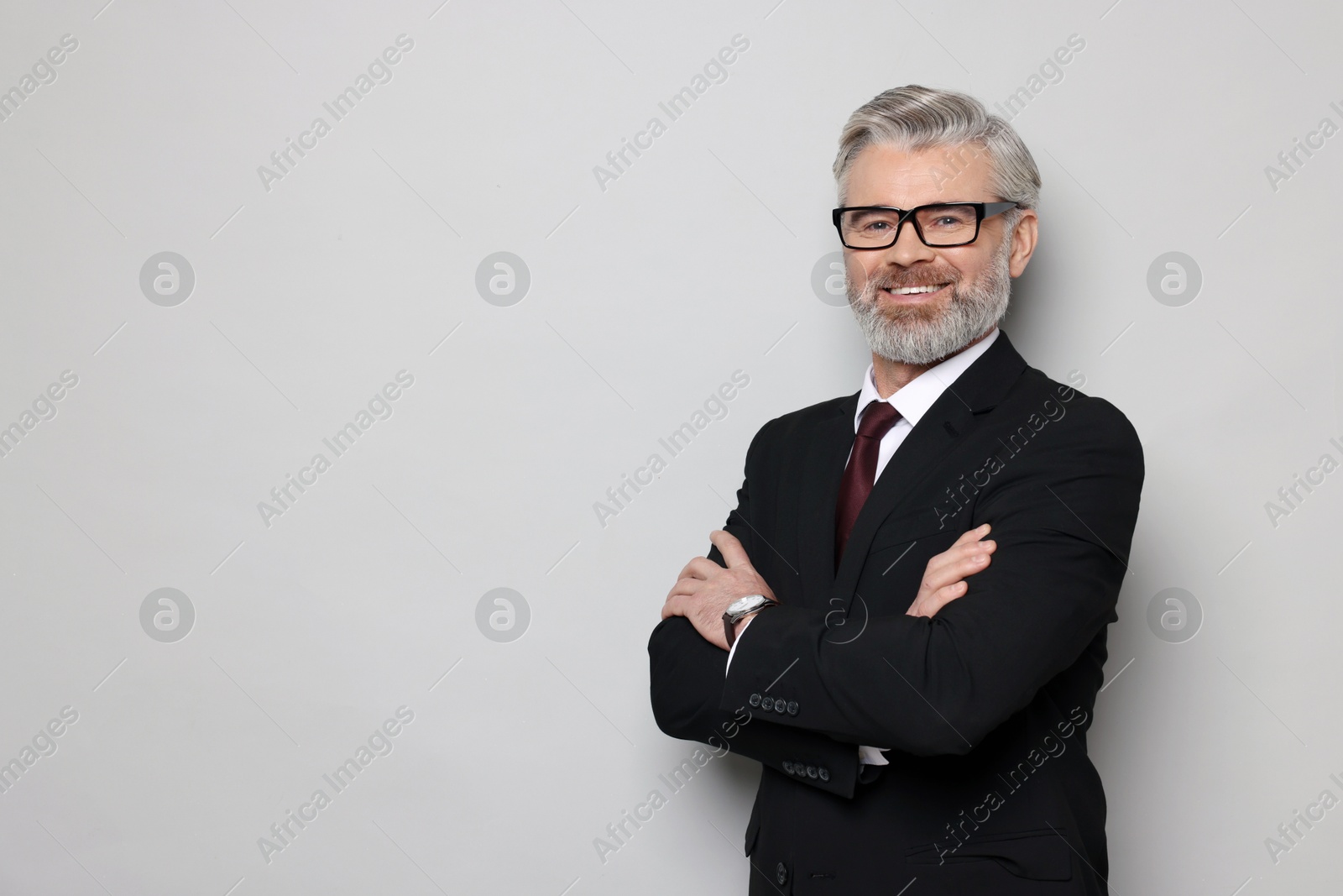 Photo of Portrait of banker in jacket on grey background, space for text