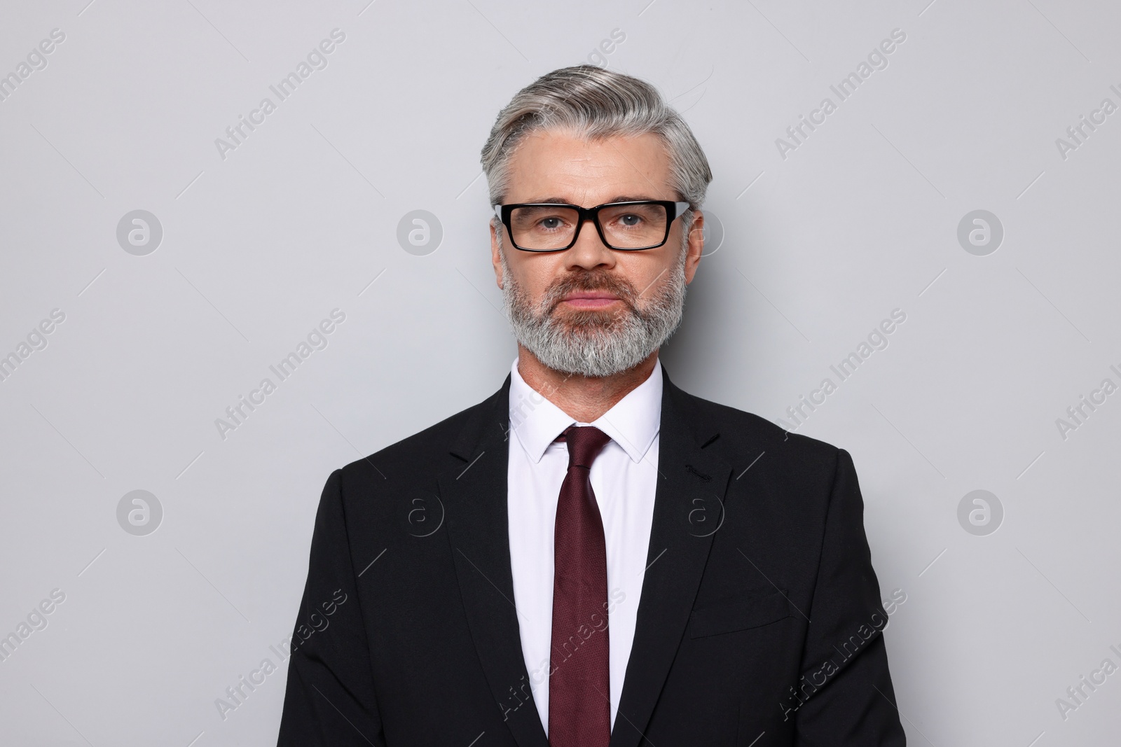 Photo of Portrait of banker in jacket on grey background