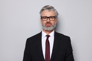 Photo of Portrait of banker in jacket on grey background