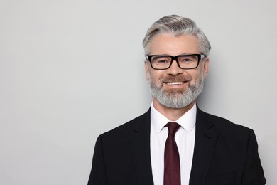 Photo of Portrait of banker in jacket on grey background, space for text