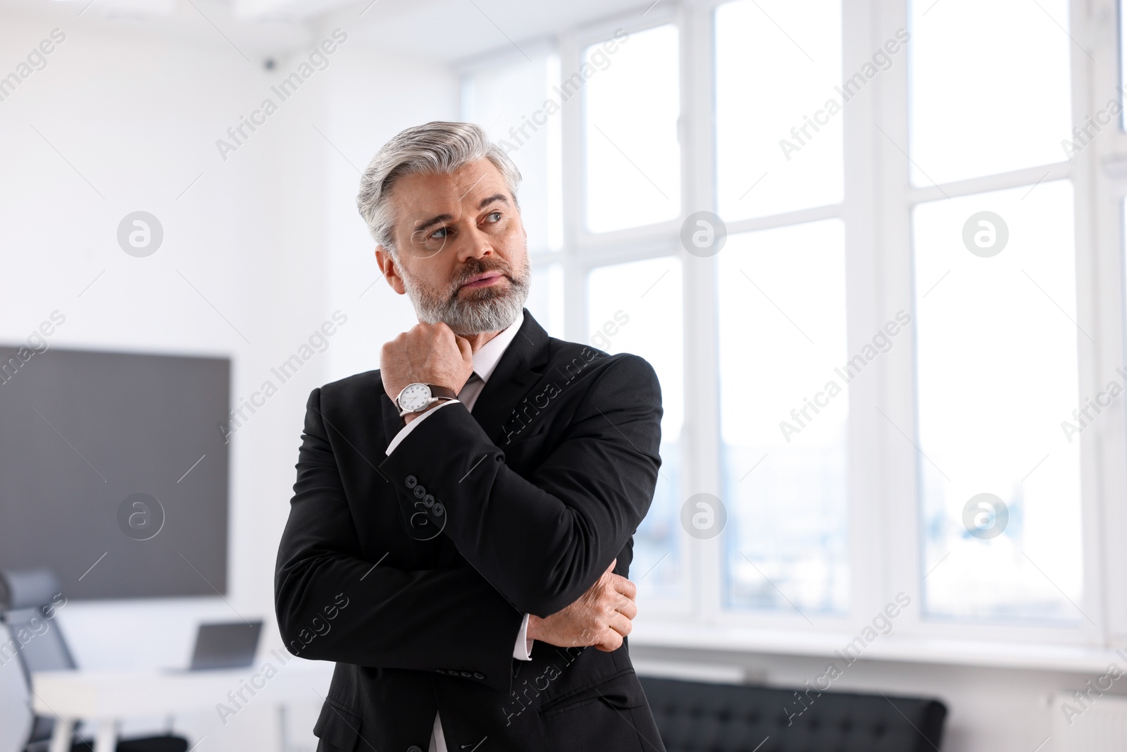 Photo of Portrait of banker in jacket indoors, space for text