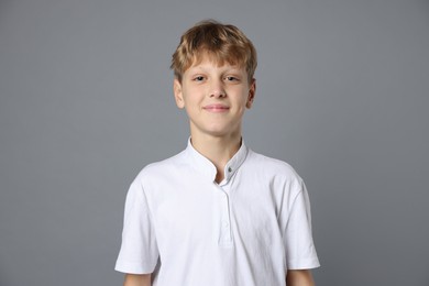 Photo of Portrait of teenage boy on grey background