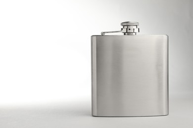 Photo of One hip flask on light table, space for text