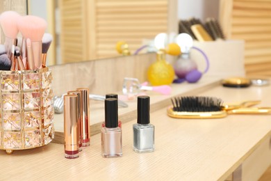 Photo of Makeup room. Different beauty products on wooden dressing table, closeup