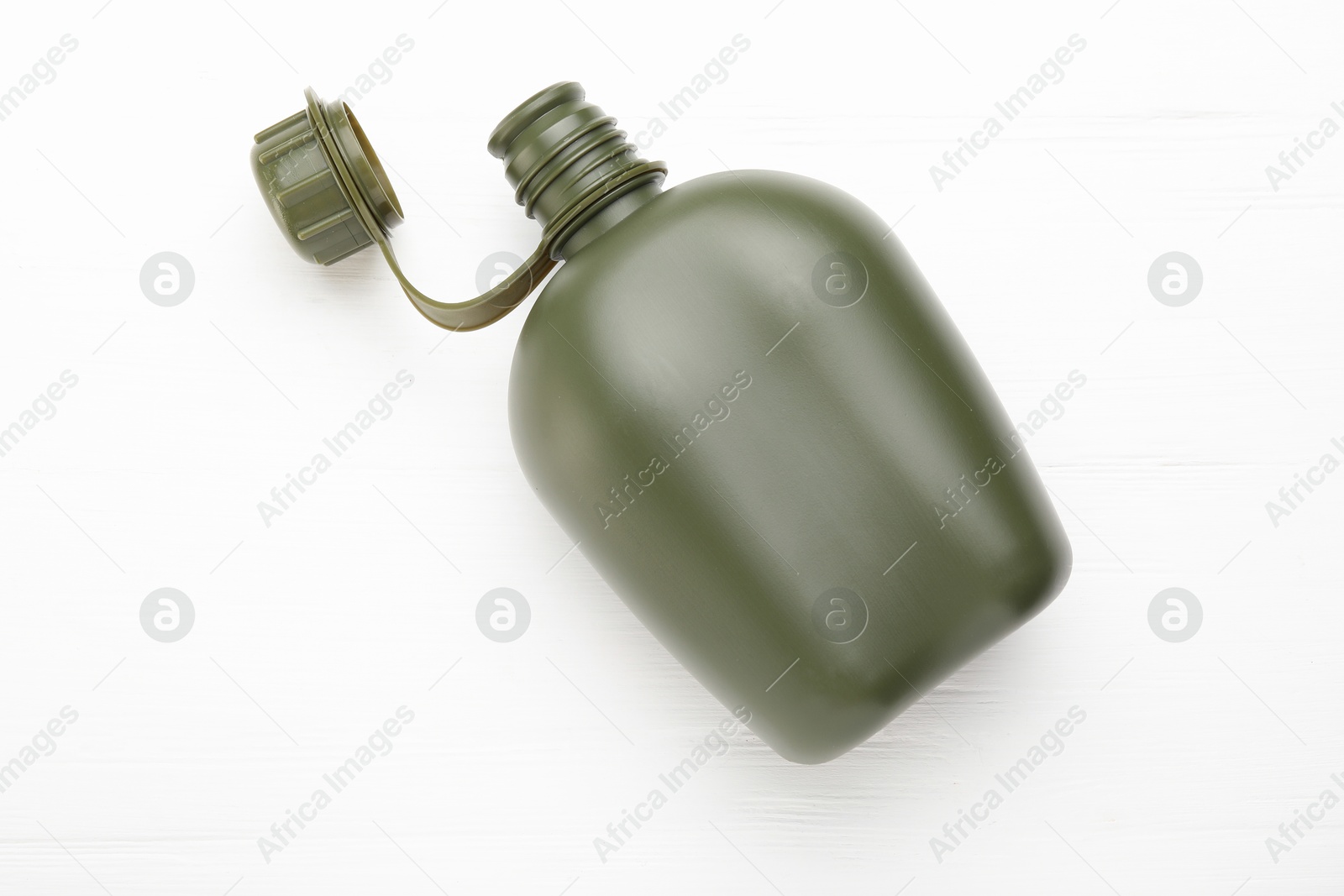 Photo of Green plastic canteen on white wooden table, top view