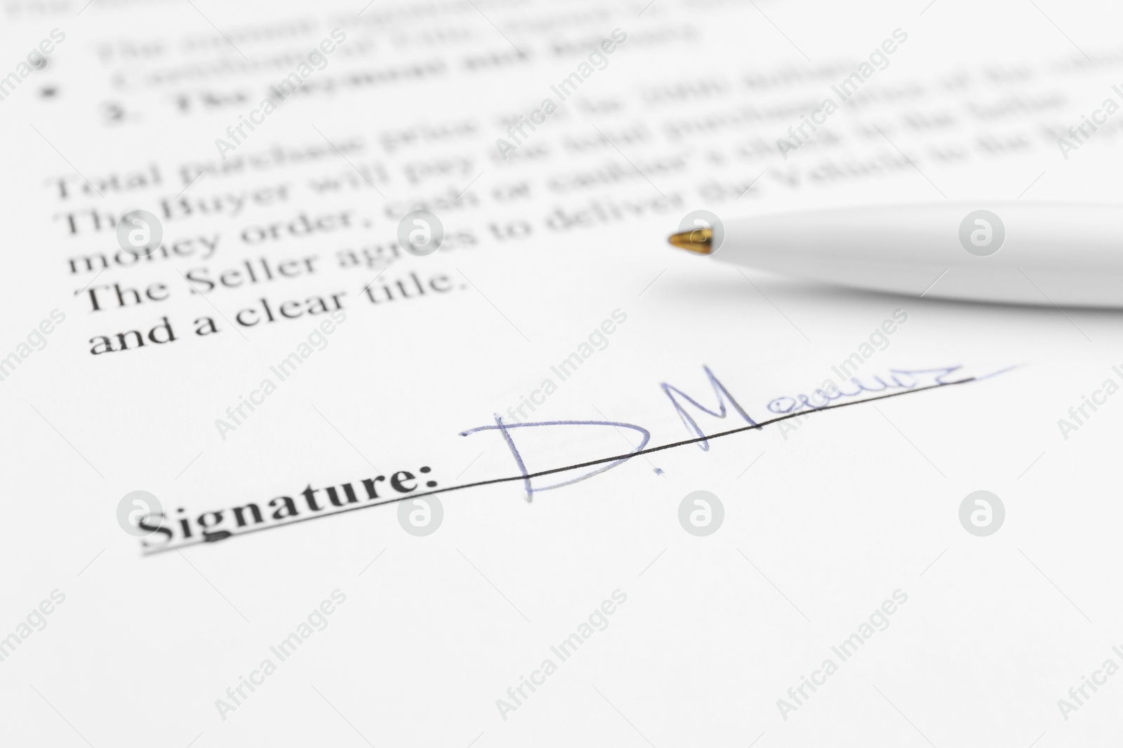 Photo of Ballpoint pen and signature on contract, closeup