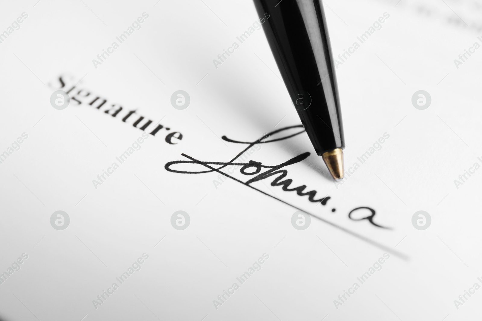 Photo of Ballpoint pen and signature on contract, closeup