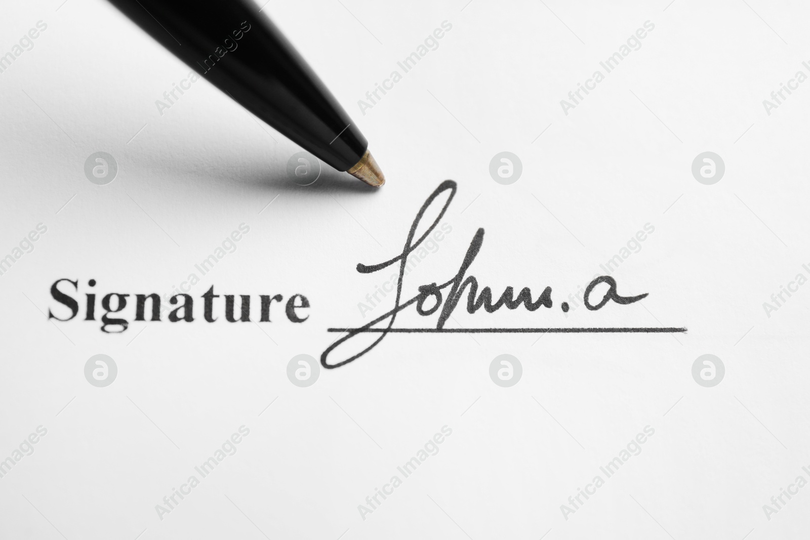 Photo of Ballpoint pen and signature on contract, top view