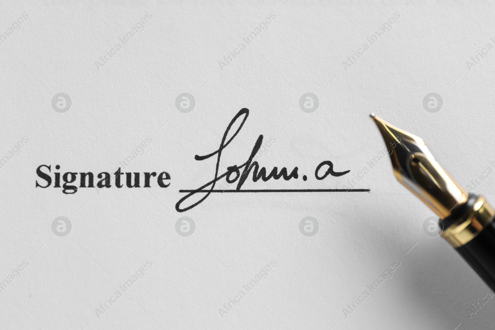 Photo of Fountain pen and signature on contract, top view