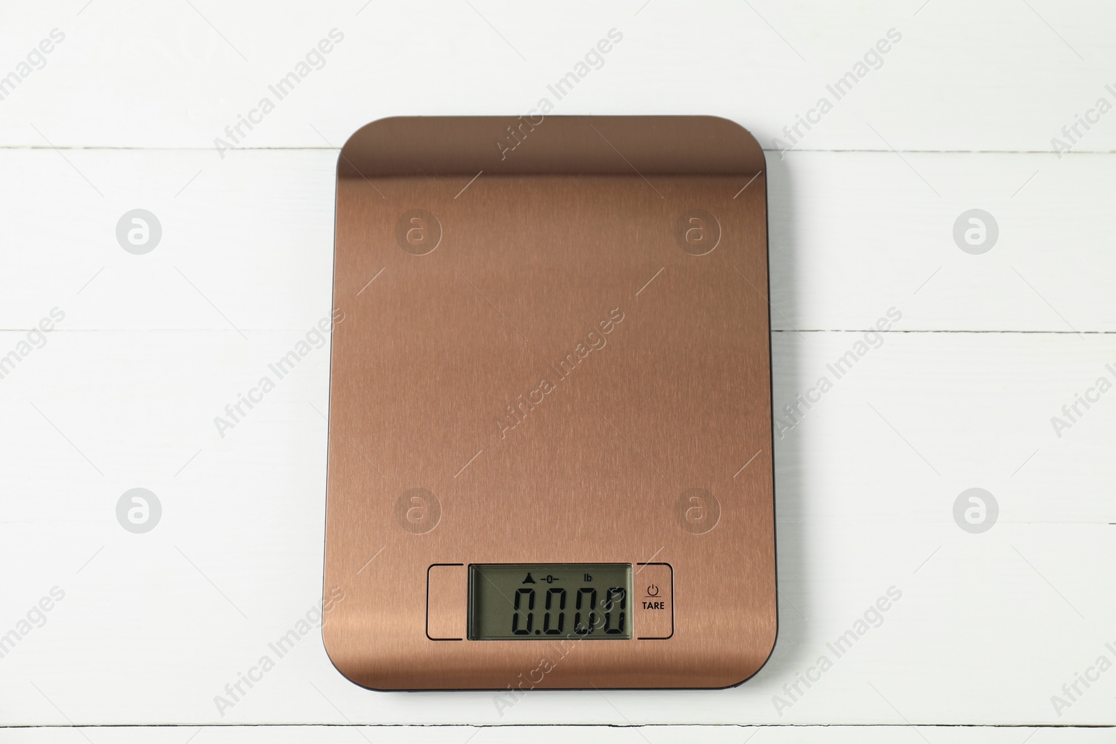 Photo of Modern electronic kitchen scale on white wooden table, top view