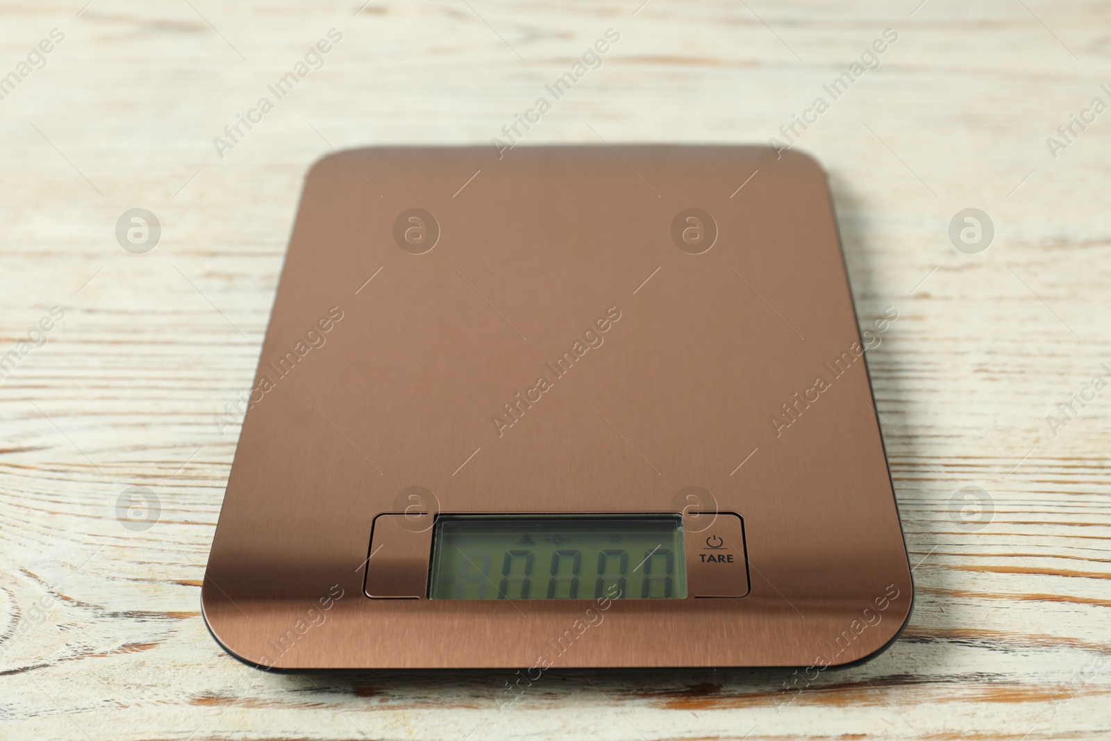 Photo of Modern electronic kitchen scale on wooden table, closeup