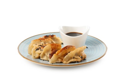 Photo of Tasty fried gyoza (dumplings) and soy sauce isolated on white