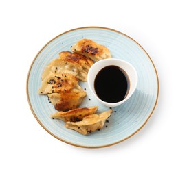 Photo of Tasty fried gyoza (dumplings) and soy sauce isolated on white, top view