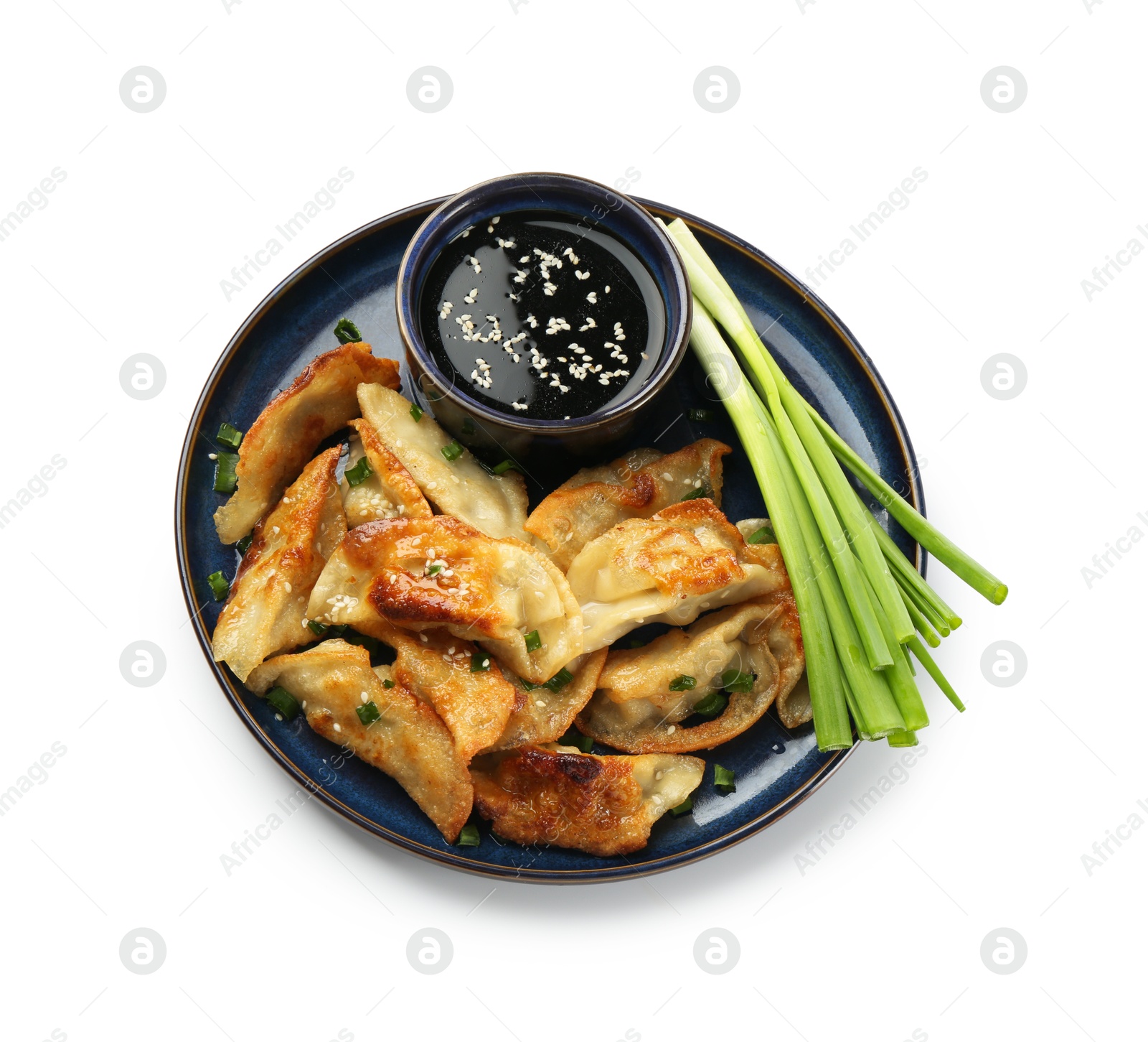 Photo of Tasty fried gyoza (dumplings), onion and soy sauce isolated on white, top view