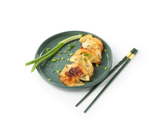 Photo of Tasty fried gyoza (dumplings), onion and chopsticks isolated on white