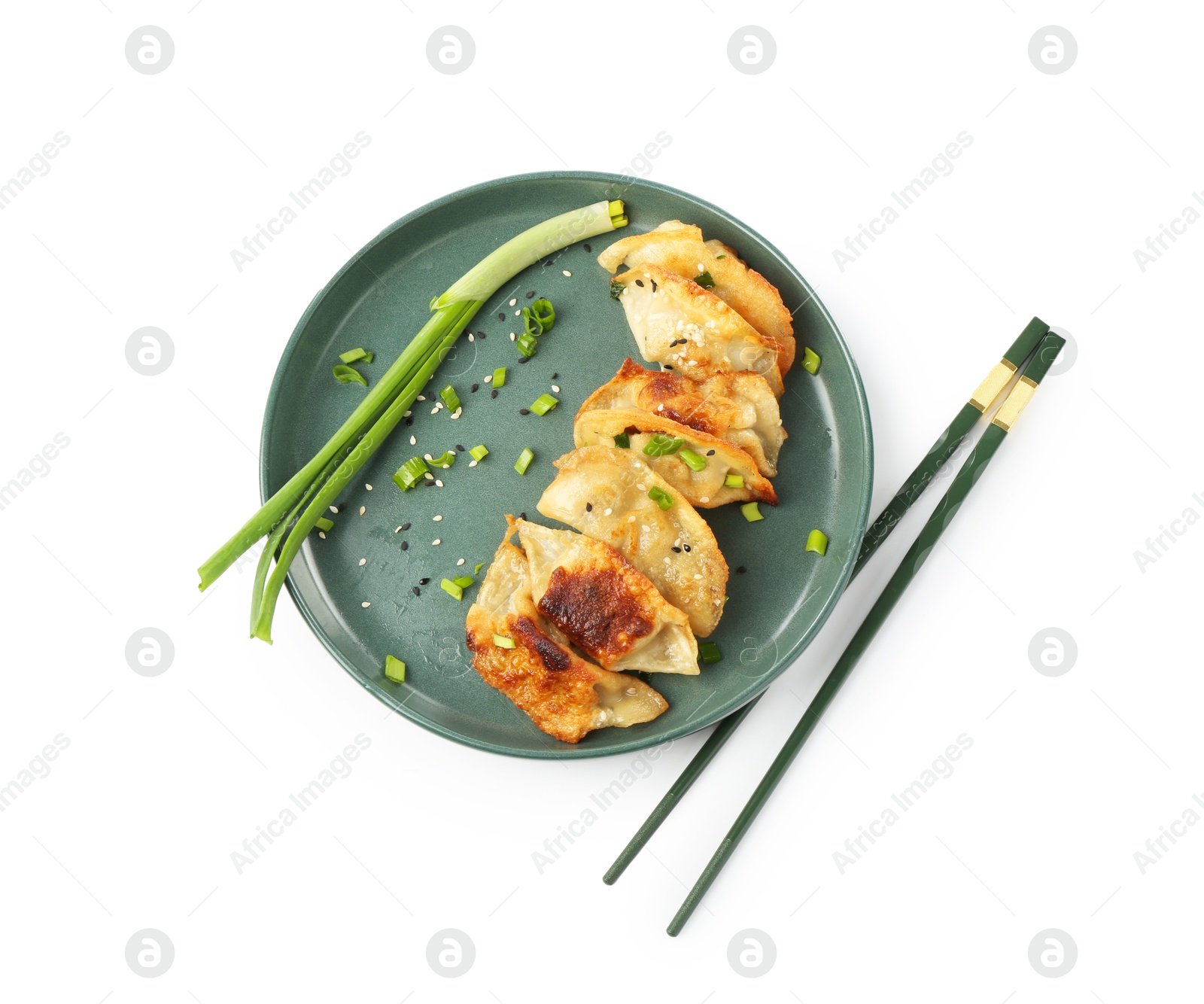 Photo of Tasty fried gyoza (dumplings), onion and chopsticks isolated on white, top view