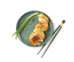 Photo of Tasty fried gyoza (dumplings), onion and chopsticks isolated on white, top view