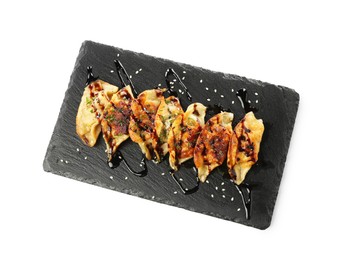 Photo of Tasty fried gyoza (dumplings) isolated on white, top view