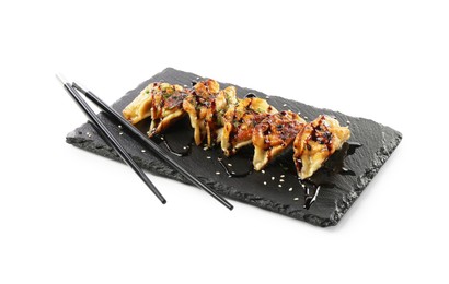 Photo of Tasty fried gyoza (dumplings) and chopsticks isolated on white