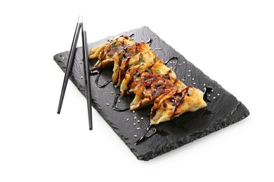 Photo of Tasty fried gyoza (dumplings) and chopsticks isolated on white