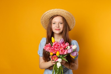 Photo of Beautiful teenage girl with bouquet of tulips on orange background