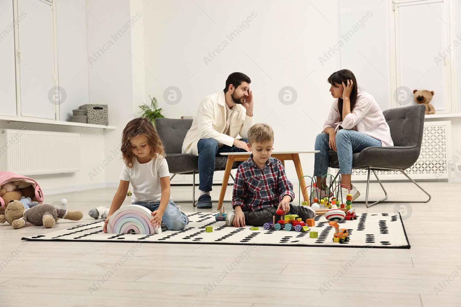 Photo of Hyperactive children playing and their overwhelmed parents at home