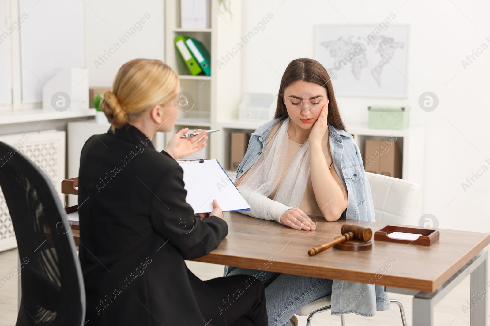 Photo of Injured woman having meeting with lawyer in office